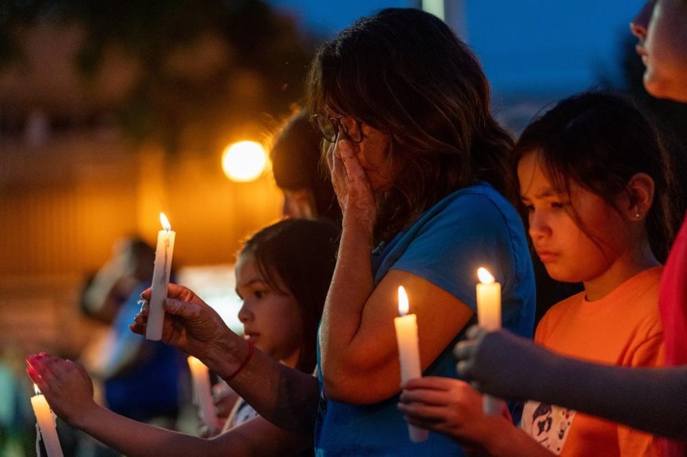 People hold candles at a vigil remembering the victims of a mass stabbing incident at James Smith Cree Nation and Weldon, Sask., in front of City Hall in Prince Albert, Sask., on Wednesday, September 7, 2022. A new project in the town of Weldon is paying tribute to the memory of one of the victims of mass attack. THE CANADIAN PRESS/Heywood Yu