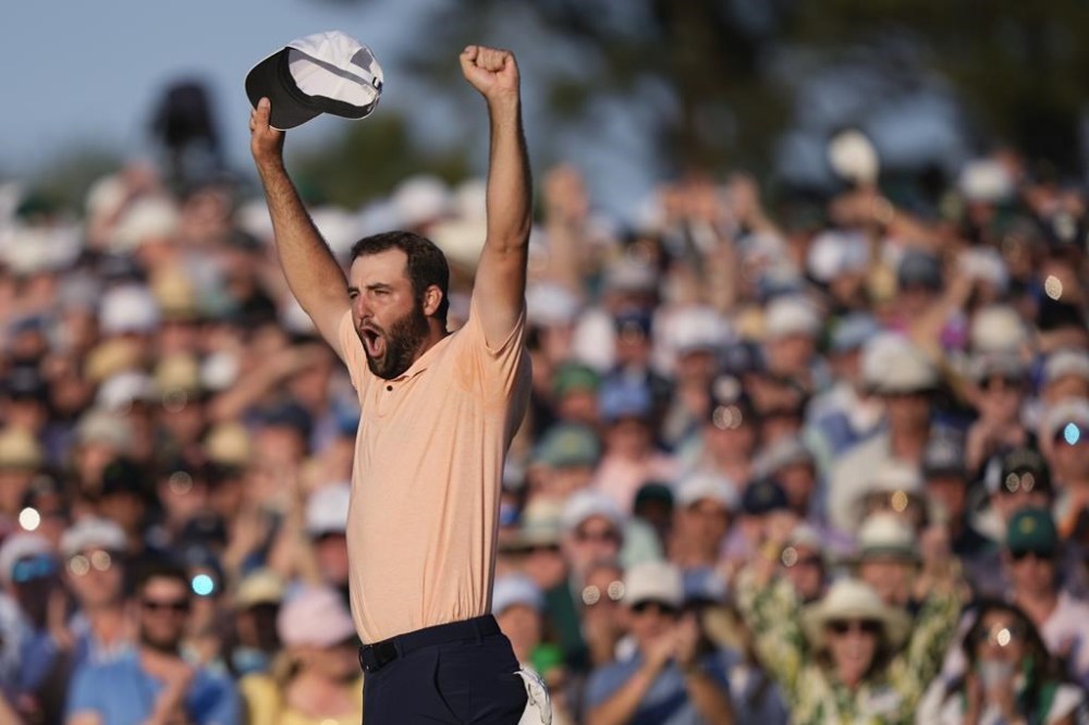 Scottie Scheffler celebrates his win at the Masters golf tournament at Augusta National Golf Club Sunday, April 14, 2024, in Augusta, Ga. (AP Photo/Charlie Riedel)
