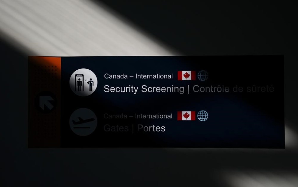 The Federal Court of Appeal says people can be barred from Canada under espionage-related provisions of the immigration law only when their activities have a clear link to Canada's security. A security sign is pictured at the Ottawa International Airport in Ottawa on Wednesday, May 10, 2023. THE CANADIAN PRESS/Sean Kilpatrick