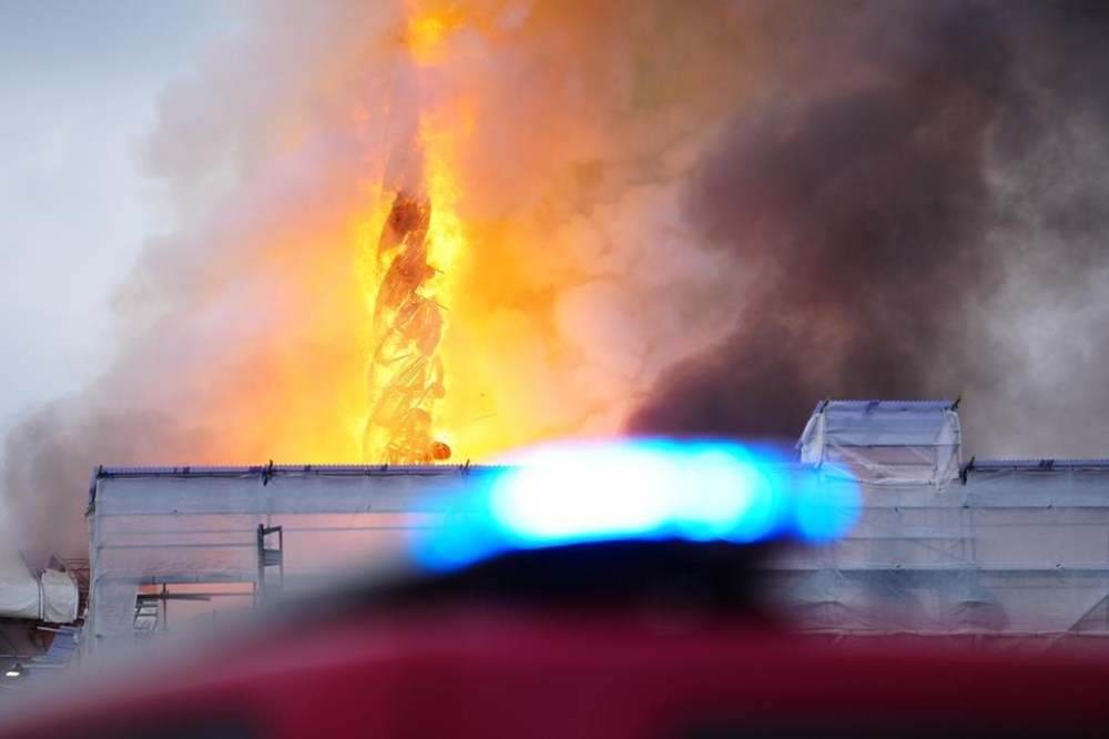 Fire and smoke rise out of the Old Stock Exchange, Boersen, in Copenhagen, Denmark, Tuesday, April 16, 2024. (Ida Marie Odgaard/Ritzau Scanpix via AP)