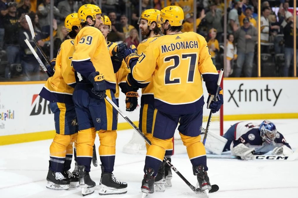 Nashville Predators' Roman Josi (59) is congratulated bt teammates after scoring against Columbus Blue Jackets goaltender Jet Greaves, back right, during the second period of an NHL hockey game Saturday, April 13, 2024, in Nashville, Tenn. (AP Photo/Mark Humphrey)