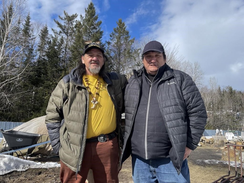 Grégoire and Michael Canapé stand near the cooling rocks of the sweat ceremony lodge at Waseskun Healing Centre, an Indigenous-run facility that is is the equivalent of a minimum-security penitentiary, in Saint-Alphonse-Rodriguez, Que., on March 20, 2024. The brothers are members of the Midewiwin Society of religious elders, healers and spiritual advisers. THE CANADIAN PRESS/Ally Lemieux Fanset