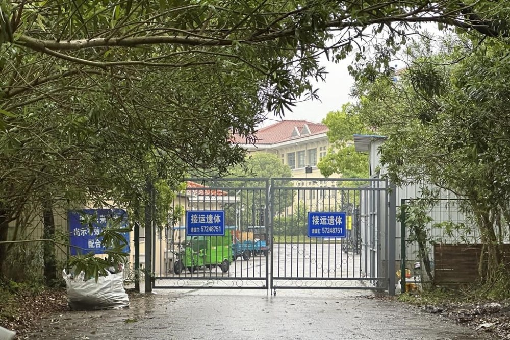Buildings in the Shanghai Public Health Clinical Center stand near the entrance of the compound in Shanghai, China, Tuesday, April 30, 2024. Zhang Yongzhen, the first scientist to publish a sequence of the COVID-19 virus, staged a sit-in protest after authorities locked him out of his lab at the center. (AP Photo/Dake Kang)