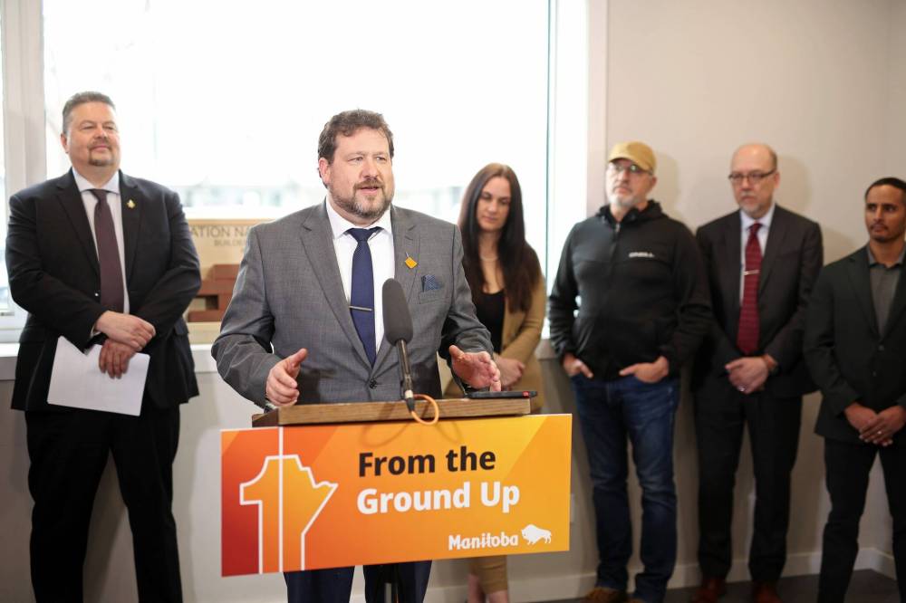 Minister of Sport, Culture, Heritage and Tourism and Brandon East MLA Glen Simard speaks during the announcement of a new community development program with provincial Municipal and Northern Relations Minister Ian Bushie (far left) at the Brandon Neighbourhood Renewal Corporation on Monday. (Tim Smith/The Brandon Sun)