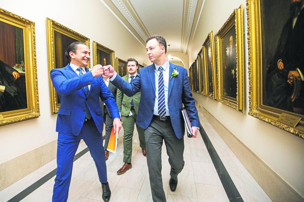 Premier Wab Kinew and Finance Minister Adrian Sala fist bump before walking in to speak to the media on budget day at the Manitoba Legislative Building in March. Sala — who is also the minister in charge of Manitoba Hydro — predictably blamed the previous Pallister and Stefanson governments last week for not making timely Centra Gas rate applications.(Mikaela MacKenzie/Winnipeg Free Press files)