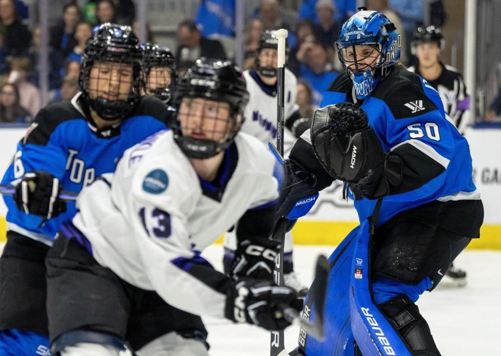 Toronto goaltender Kristen Campbell (50) keeps an eye on the play as Toronto's Kali Flanagan (6) controls Minnesota's Grace Zumwinkle (13) during second period PWHL playoff hockey action in Toronto on Wednesday, May 8, 2024.THE CANADIAN PRESS/Frank Gunn