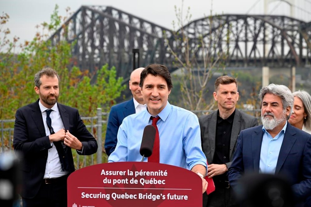 Prime Minister Justin Trudeau announces the purchase of the Quebec Bridge from Canadian National, Wednesday, May 15, 2024 in Quebec City. From left, MP Joel Lightbound, Jean-Yves Duclos, minister of public services and procurement, Trudeau, Quebec City Mayor Bruno Marchand and Minister of Transport Pablo Rodriguez. THE CANADIAN PRESS/Jacques Boissinot