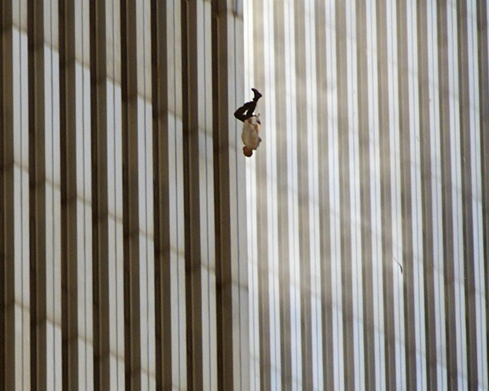 EDS NOTE: GRAPHIC CONTENT - FILE - A person falls from the north tower of New York's World Trade Center Tuesday Sept. 11, 2001after terrorists crashed two hijacked airliners into the World Trade Center and brought down the twin 110-story towers. A new exhibition of photographs owned by Elton John opens this week at London’s Victoria and Albert Museum. It includes more than 300 pieces by 140 photographers selected from the vast collection of John and his husband David Furnish. (AP Photo/Richard Drew, File)