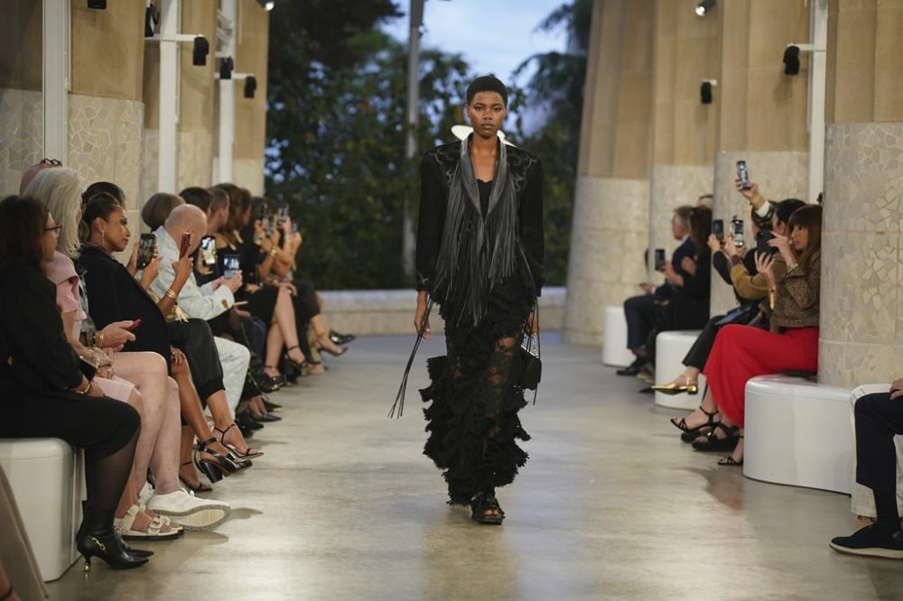 A model wears a creation by Louis Vuitton during a fashion show for the Cruise 2025 collection in the Park Guell in Barcelona, Spain, Thursday, May 23, 2024. (AP Photo/Joan Mateu)