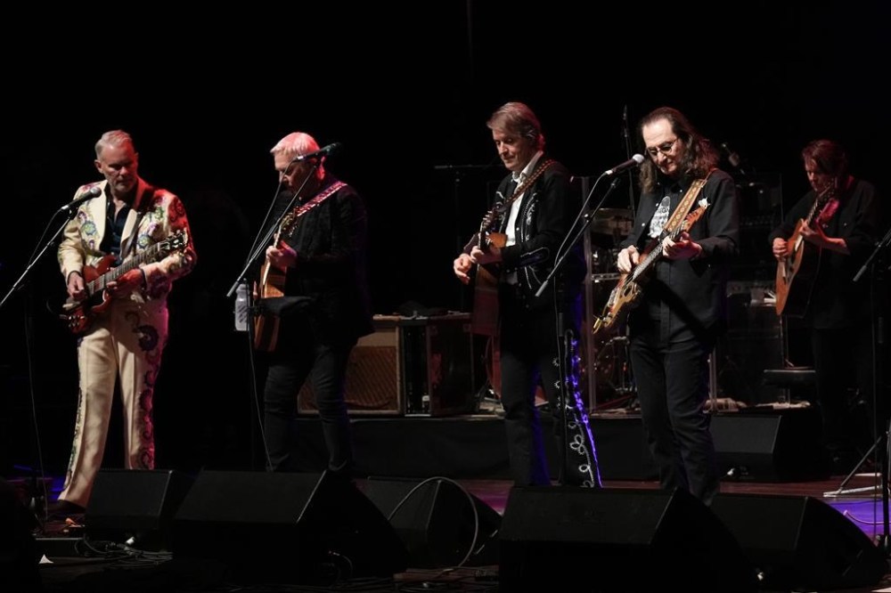 Rush's Geddy Lee, right, and Alex Lifeson, second left, join members of Blue Rodeo in performing