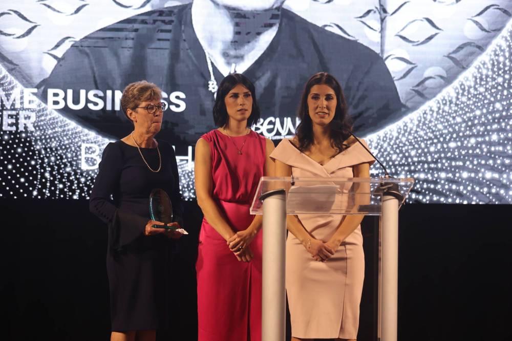 Debbie Hernandez (left) and daughters Natalie Bell and Elizabeth receive the Lifetime Business Award in honour of Ben Hernandez.