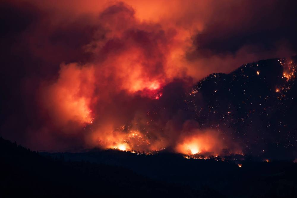 A wildfire is shown burning on the side of a mountain in Lytton, B.C.on July 1, 2021. École secondaire Neelin High School student Colin Shaw writes on the important role journalism plays in addressing threats to the environment. (The Canadian Press)