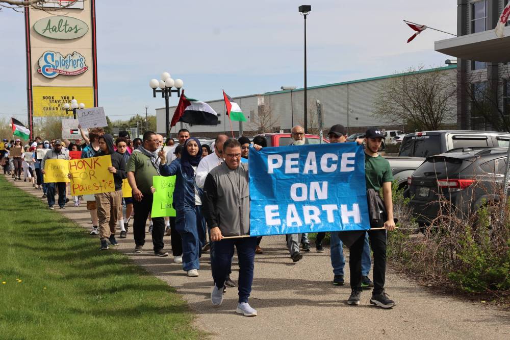 About 70 Brandon residents from various backgrounds, including the Pakistani, Indian, and African communities, partake in a Gaza ceasefire walk, covering 4.8 kilometres from Knox United Church to Richmond Avenue, and back on Saturday. (Abiola Odutola/The Brandon Sun)