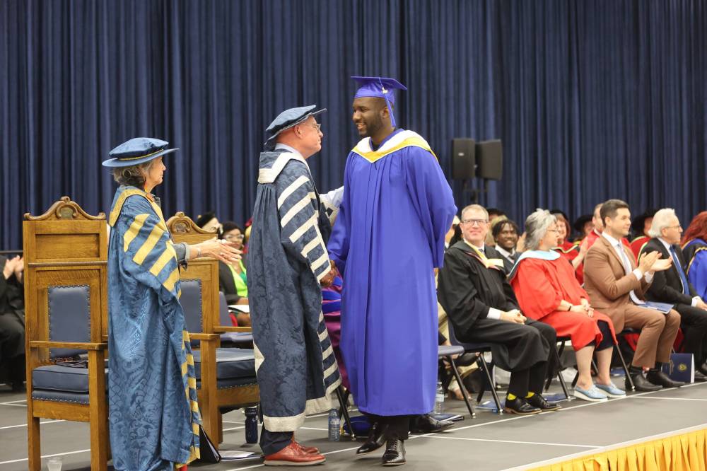 Brandon University president David Docherty congratulates Chukwuanugo Okudo on earning his bachelor of science degree during the annual convocation ceremony on Thursday morning. (Abiola Odutola/The Brandon Sun