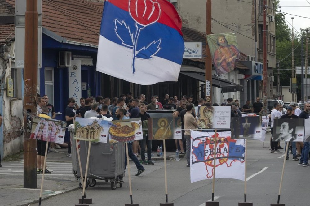 Right-wing extremists gather on a street in central Belgrade, Serbia, Thursday, June 27, 2024. Serbian police on Thursday banned a festival that promotes cultural exchange with Kosovo, in a sign of growing nationalism and government pressure on liberal voices in the Balkan country. The police ban came after several dozen right-wing extremists gathered outside the festival venue, seeking to prevent its holding while waving Serbian flags. (AP Photo/Marko Drobnjakovic)