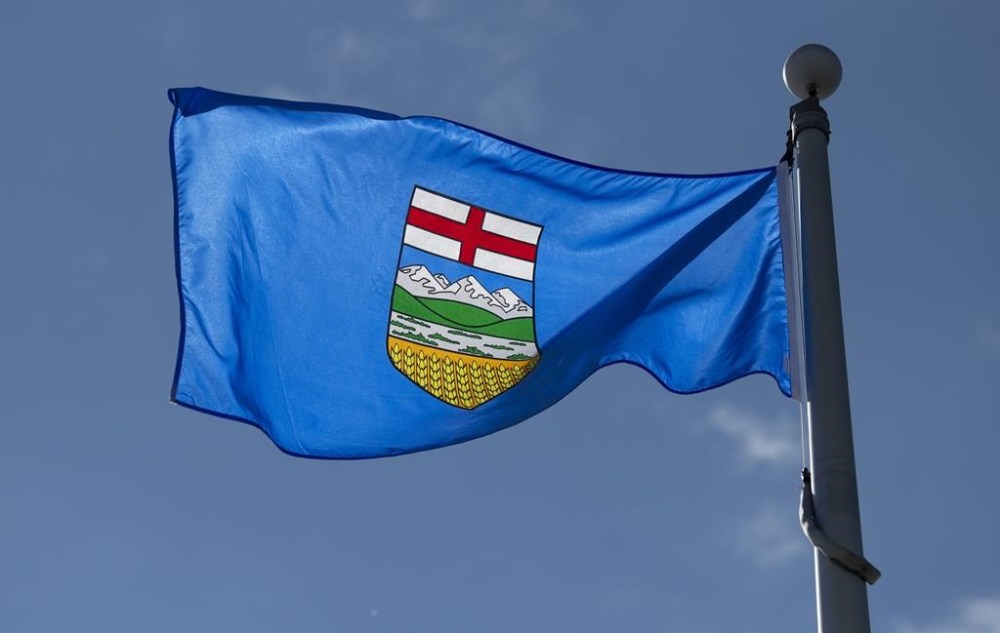 Legal Aid Alberta says it will end services by next Tuesday over a contract dispute with the province. Alberta's provincial flag flies on a flag pole in Ottawa, Tuesday June 30, 2020. THE CANADIAN PRESS/Adrian Wyld