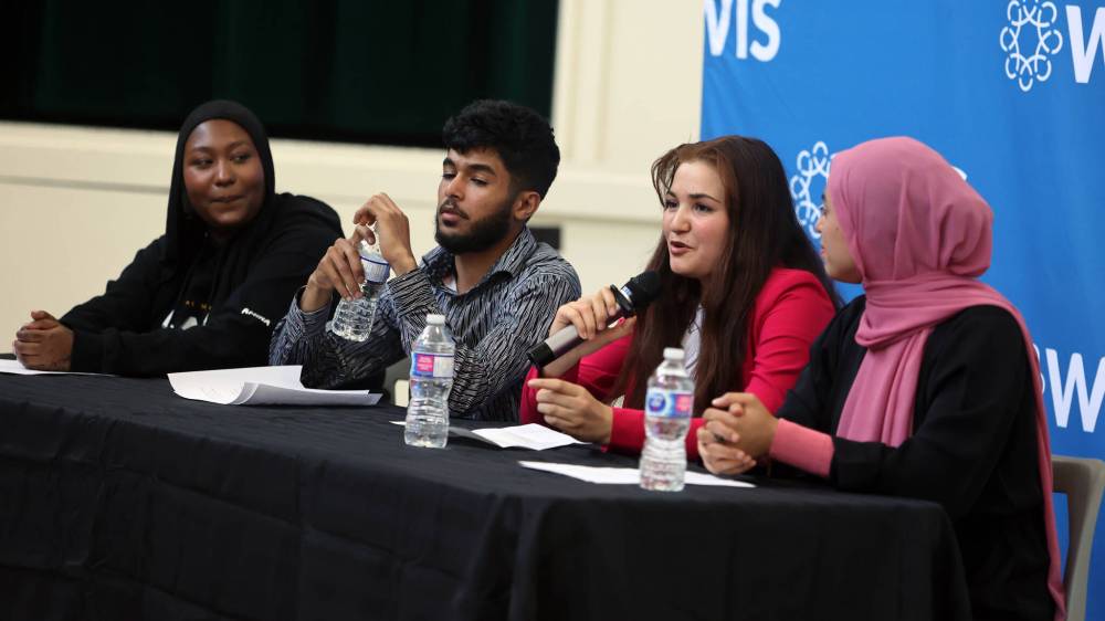 Zainab Mohammed discusses her experience coming from Turkiye to Canada during a youth panel discussion at a World Refugee Day event held by Westman Immigrant Services on Thursday as Amina Ali and Kaltoum and Jomaa Alabeid look on. (Colin Slark/The Brandon Sun)