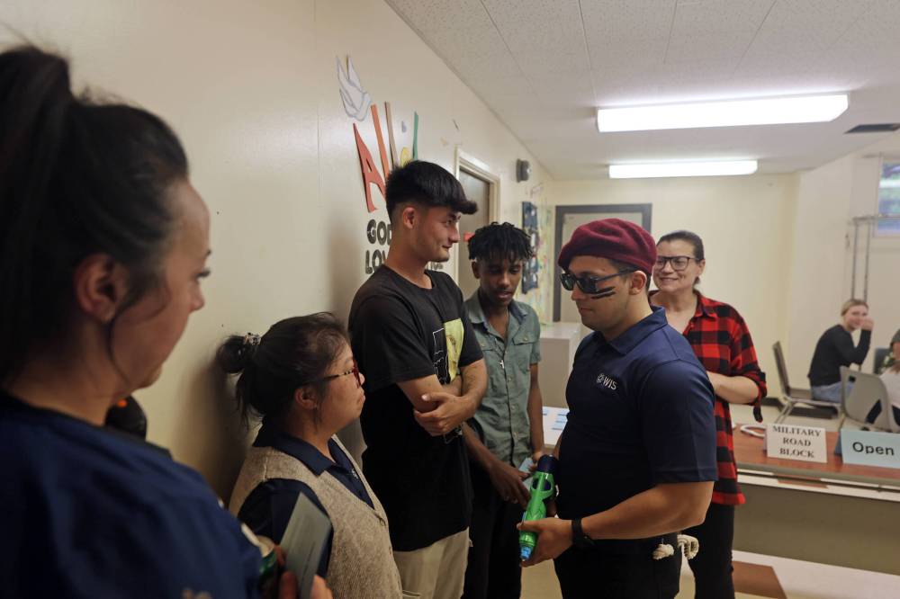 Participants in a forced migration simulation are stopped at a military roadblock during Westman Immigrant Services' World Refugee Day event at its multicultural centre on Thursday. (Colin Slark/The Brandon Sun)