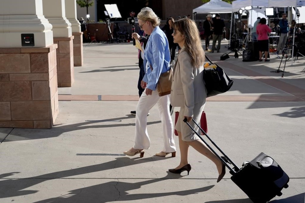 Prosecutors Kari Morrissey, left, and Erlinda Ocampo Johnson, right, arrive for jury selection in Actor Alec Baldwin's involuntary manslaughter trial, Tuesday, July 9, 2024, in Santa Fe, N.M. (AP Photo/Ross D. Franklin)