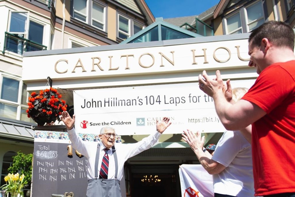 Second World War veteran John Hillman, shown in a handout photo, raises his hands in triumph after completing 104 laps of his Victoria, B.C., retirement home as part of an annual fundraising walk for Save the Children, one lap for each year of his life. Hillman died Monday at the age of 105. THE CANADIAN PRESS /HO
