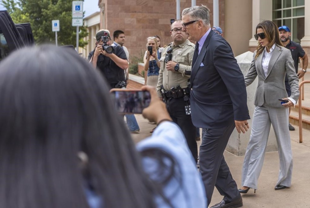 Actor Alec Baldwin, center right, and his wife Hilaria leave court the judge threw out the involuntary manslaughter case for the 2021 fatal shooting of cinematographer Halyna Hutchins during filming of the Western movie