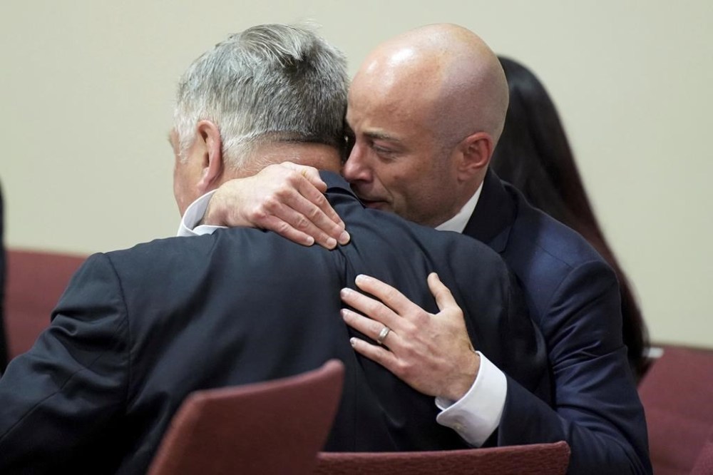 Attorney Luke Nikas, right, embraces actor Alec Baldwin during his trial for involuntary manslaughter for the 2021 fatal shooting of cinematographer Halyna Hutchins during filming of the Western movie