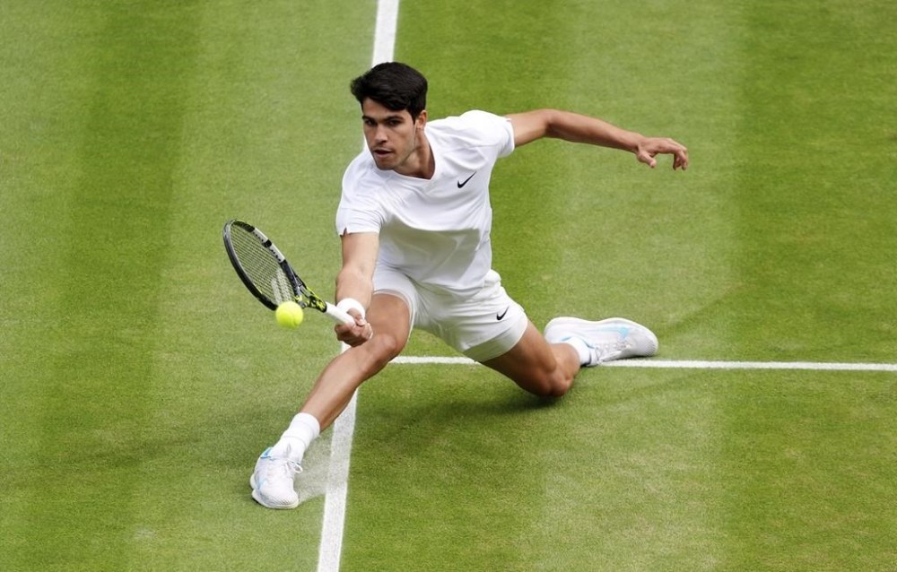 Carlos Alcaraz of Spain returns the ball to Novak Djokovic of Serbia during the men's singles final at the Wimbledon tennis championships in, Sunday, July 14, 2024. (John Walton/PA via AP)