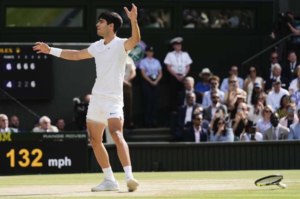 Carlos Alcaraz of Spain celebrates after defeating Novak Djokovic of Serbia during the men's singles final at the Wimbledon tennis championships in London, Sunday, July 14, 2024. (AP Photo/Kirsty Wigglesworth)