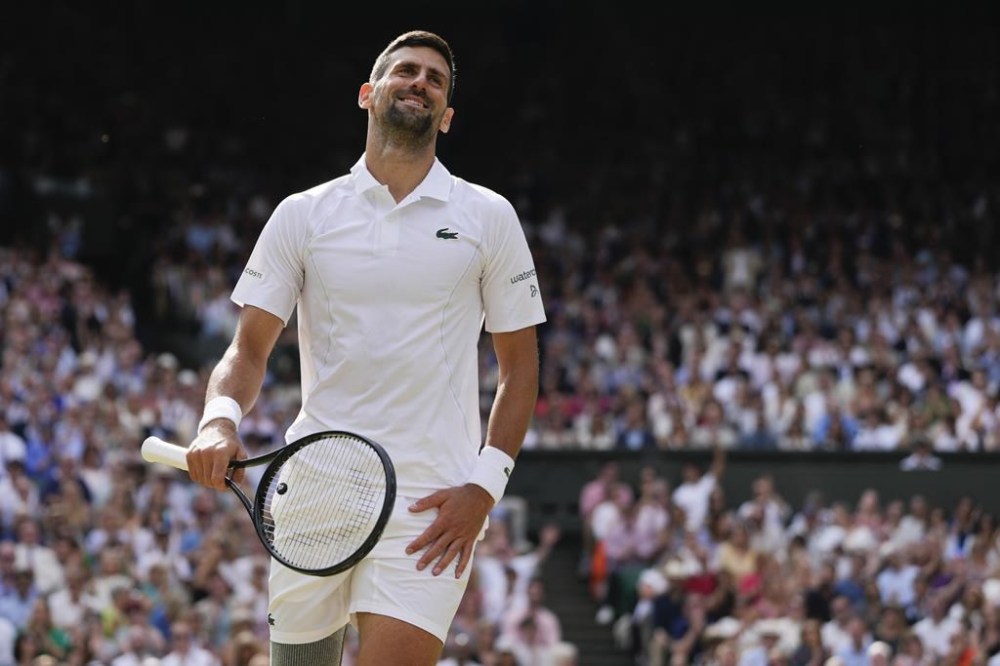 Novak Djokovic of Serbia reacts during his match against Carlos Alcaraz of Spain in the men's singles final at the Wimbledon tennis championships in London, Sunday, July 14, 2024. (AP Photo/Kirsty Wigglesworth)