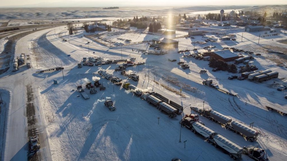 A truck convoy of anti-COVID-19 vaccine mandate demonstrators continue to block the highway at the busy U.S. border crossing in Coutts, Alta., on Feb. 2, 2022. THE CANADIAN PRESS/Jeff McIntosh