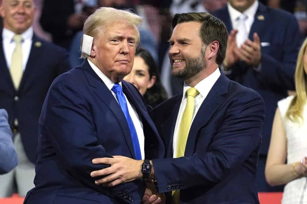 FILE - Republican presidential candidate former President Donald Trump, left, is introduced alongside Republican vice presidential candidate Sen. JD Vance, R-Ohio, during the Republican National Convention, July 16, 2024, in Milwaukee. Trump is returning to the campaign trail in Michigan as he looks to win a second term in office. Trump has spent much of the week at the RNC and the trip to Michigan will be his first campaign event since an assassination attempt in Pennsylvania on July 13. (AP Photo/Paul Sancya, File)