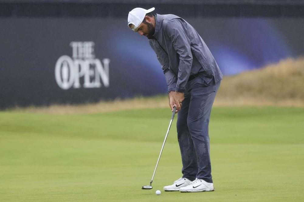 Scottie Scheffler of the United States putts on the 18th green during his third round of the British Open Golf Championships at Royal Troon golf club in Troon, Scotland, Saturday, July 20, 2024. (AP Photo/Scott Heppell)