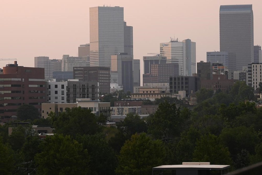 The skyline is obscured by wildfire smoke from blazes in the American West and provinces of western Canada late Wednesday, July 24, 2024, in Denver. (AP Photo/David Zalubowski)