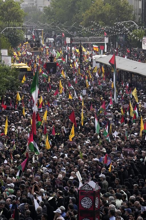 Iranians gather for the funeral ceremony of Hamas leader Ismail Haniyeh and his bodyguard who were killed in an assassination on Israel, Wednesday, at Enqelab-e-Eslami (Islamic Revolution) Sq. in Tehran, Iran, Thursday, Aug. 1, 2024. (AP Photo/Vahid Salemi)