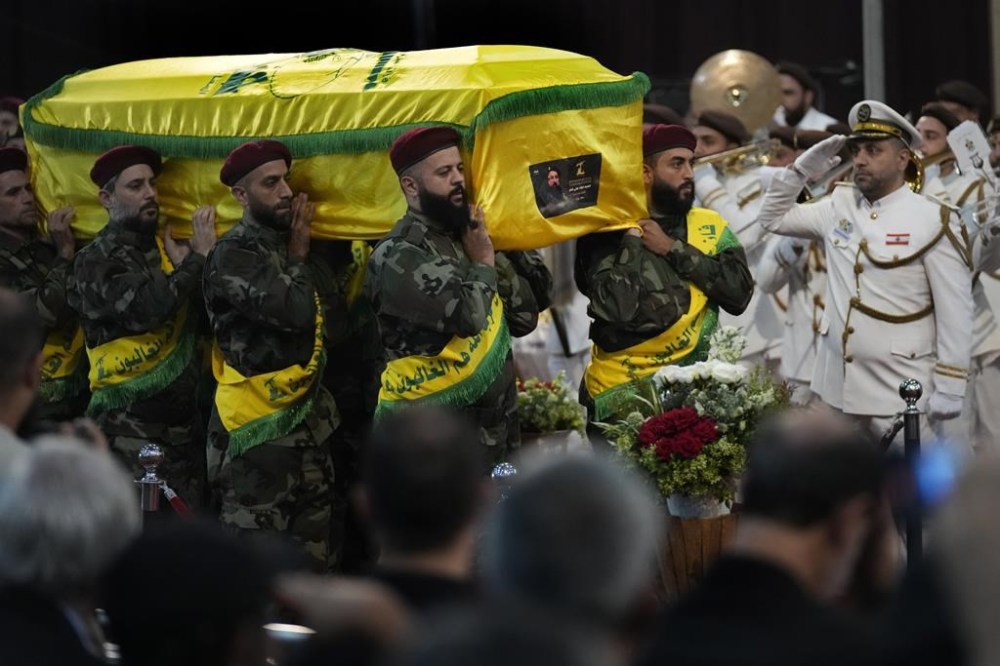 Hezbollah fighters carry the coffin of their top commander Fouad Shukur, who was killed by an Israeli airstrike on Tuesday, July 30, during his funeral procession in a southern suburb of Beirut, Lebanon, Aug. 1, 2024. (AP Photo/Hussein Malla)