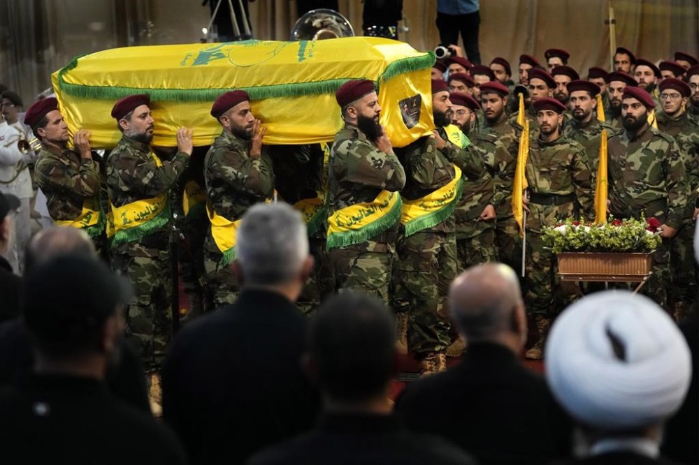 Hezbollah fighters carry the coffin of their top commander Fouad Shukur, who was killed by an Israeli airstrike on Tuesday, July 30, during his funeral procession in a southern suburb of Beirut, Lebanon, Aug. 1, 2024. (AP Photo/Hussein Malla)