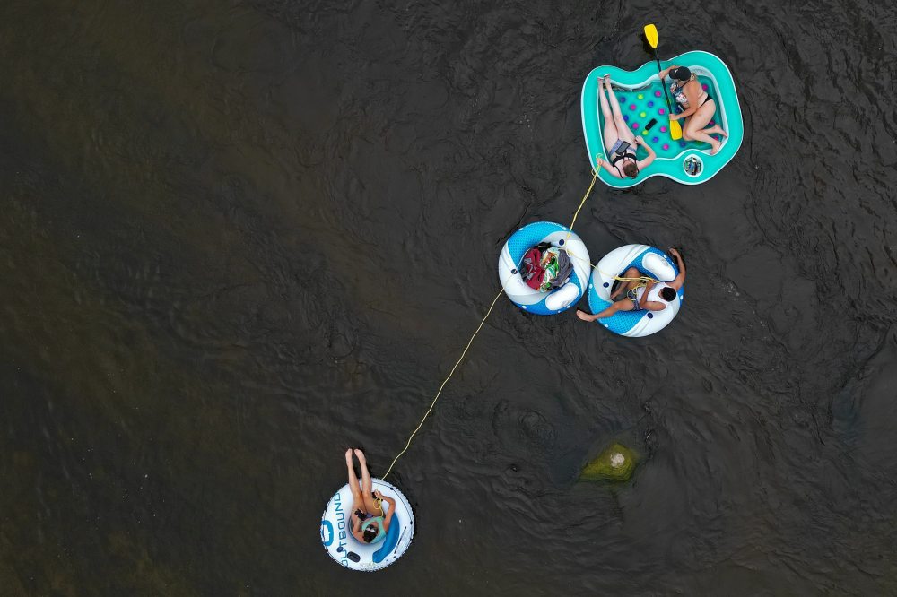 Friends Loren Lobreau (from left), Jodie Tocher, Luis Alvarenga and Cassandra Kowalchuk float down the Little Saskatchewan River west of Brandon on a hot and humid Monday afternoon.
(Tim Smith/The Brandon Sun)