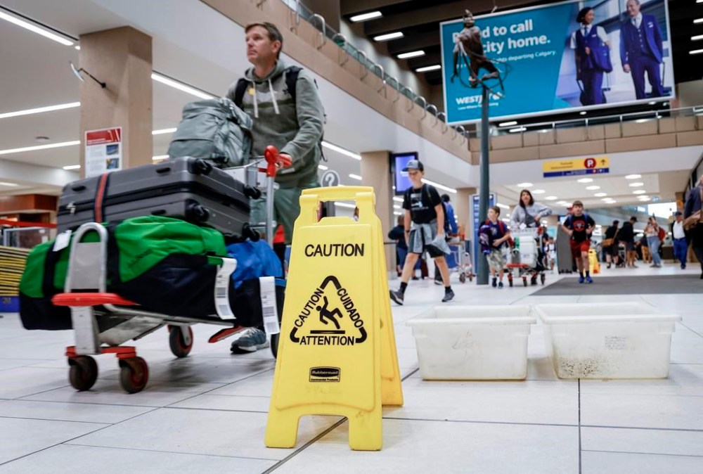An aviation expert says airfares may rise in the immediate aftermath of a hailstorm that tore through Calgary on Tuesday evening, damaging WestJet planes. Travellers manoeuvre around buckets catching leaks as repairs are underway at the Calgary International Airport after parts of its domestic terminal building were closed late Monday due to damage caused by hail and heavy rainfall, in Calgary, Tuesday, Aug. 6, 2024. THE CANADIAN PRESS/Jeff McIntosh
