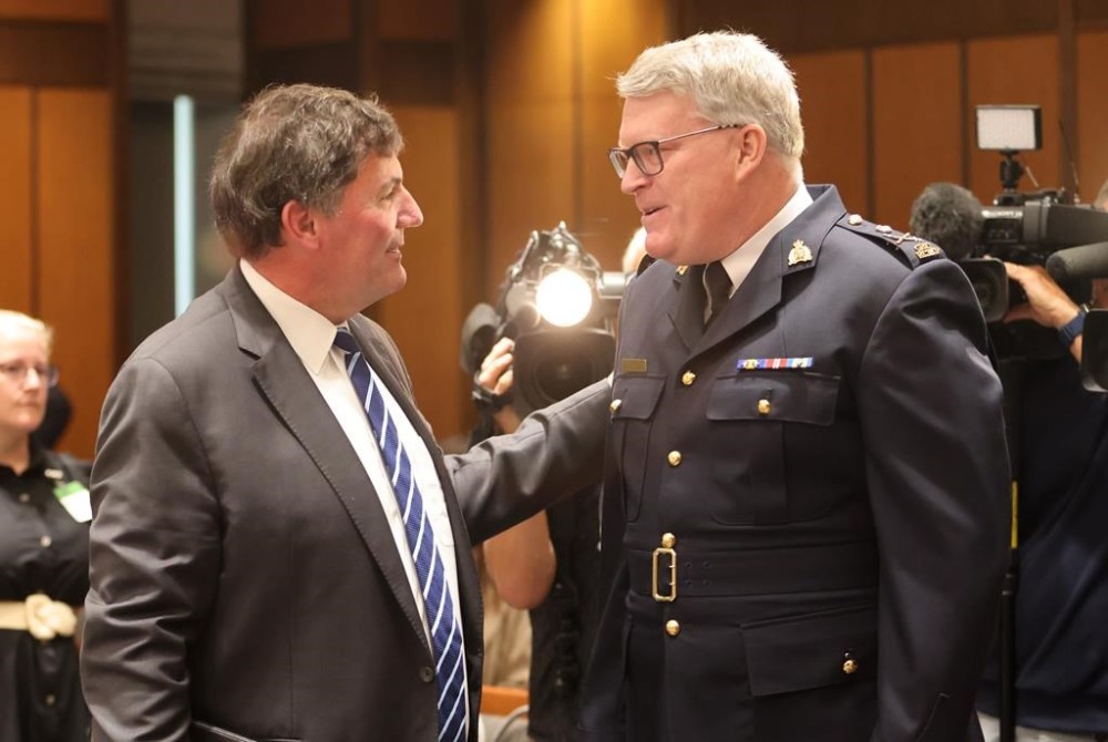 Minister of Public Safety Dominic LeBlanc and RCMP Deputy Commissioner Bryan Larkin chat before appearing at the Standing Committee on Public Safety and National Security (SECU) on Parliament Hill in Ottawa on Wednesday, Aug. 28, 2024. THE CANADIAN PRESS/ Patrick Doyle