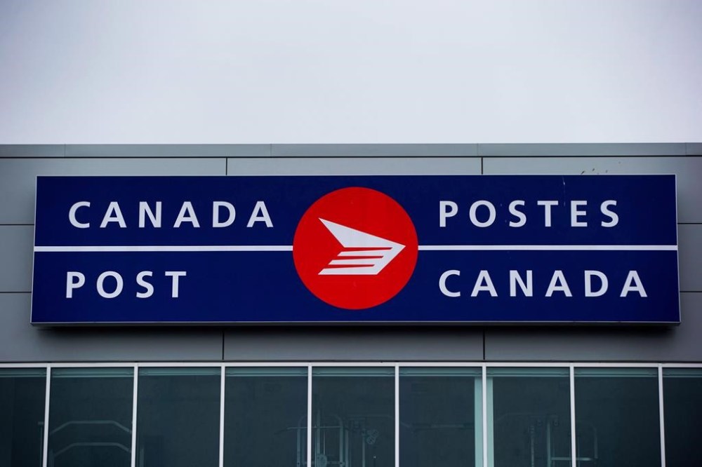 The Canada Post logo is seen on the outside the company's Pacific Processing Centre, in Richmond, B.C., on June 1, 2017. Canada Post says it's proposing an increase of regulated postage rates for 2025.THE CANADIAN PRESS/Darryl Dyck