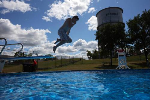 A swimmer leaps off the diving board at the Kinsmen Centennial Pool in Brandon&rsquo;s Rideau Park in this 2024 file shot. (Tim Smith/The Brandon Sun files)