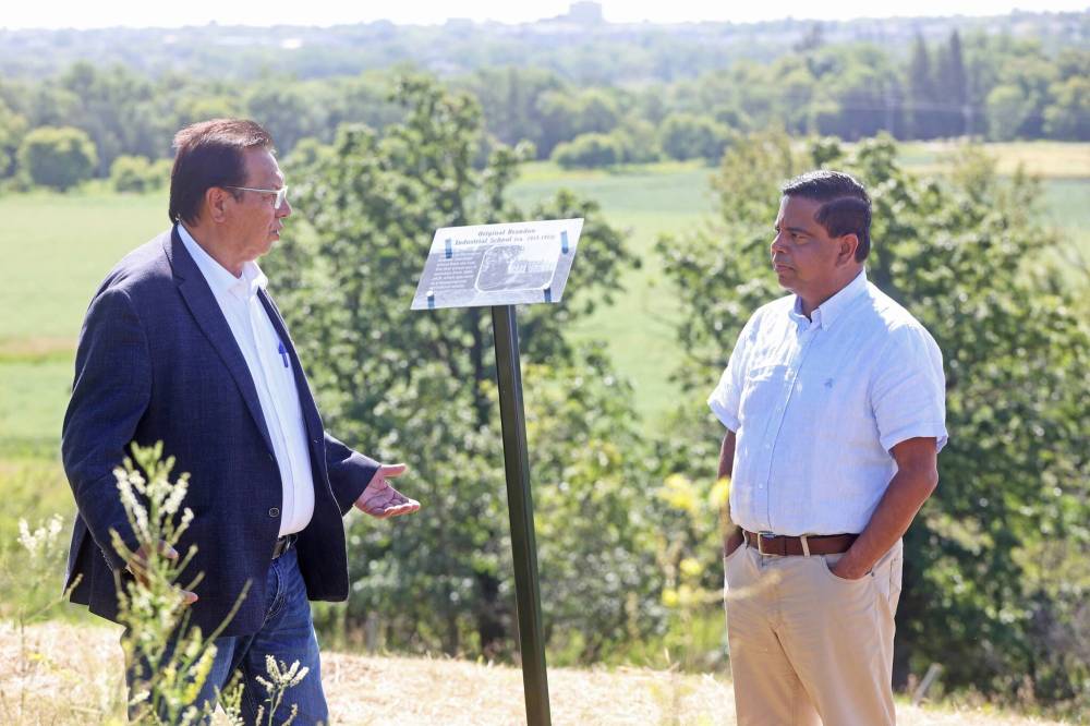 Sioux Valley Dakota Nation Chief Vince Tacan talks with Crown-Indigenous Relations Minister Gary Anandasangaree at the site of the former Brandon Indian Residential School on Monday. (Tim Smith/The Brandon Sun)