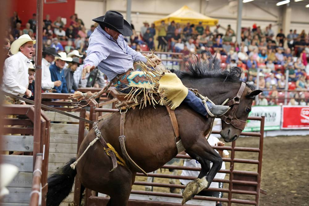 Aidan Jeffery, of Tumut, Australia, bursts out of the gate atop his horse during the Saddle Bronc event during the Virden Indoor Rodeo in 2022. This year's Virden Indoor Rodeo and Wild West Daze will kick off today with events taking place at Tundra Oil and Gas Place and throughout the town. (File)