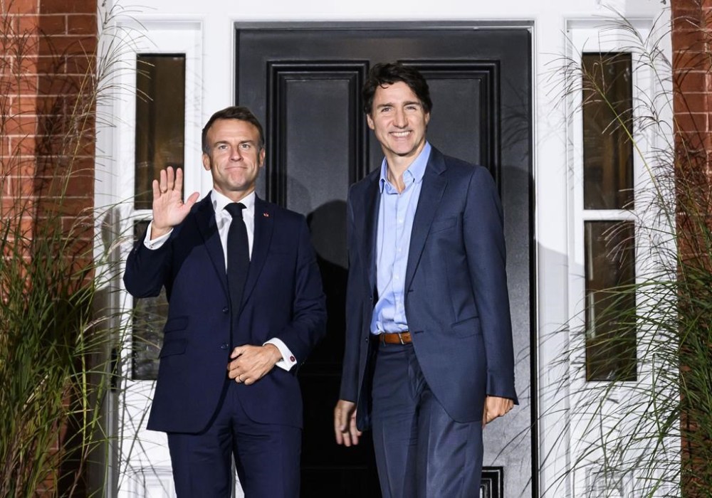 Prime Minister Justin Trudeau, right, greets French President Emmanuel Macron outside Rideau Cottage at Rideau Hall, as Macron arrives in Ottawa for a visit to Canada, on Wednesday, Sept. 25, 2024. THE CANADIAN PRESS/Justin Tang
