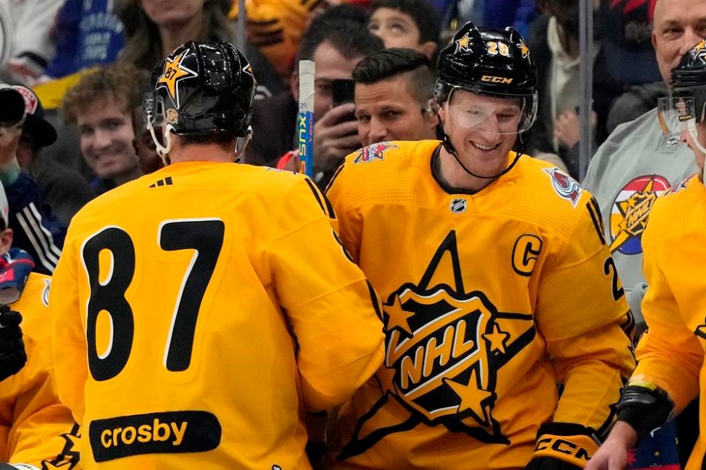 Team MacKinnon captain Nathan MacKinnon (29), of the Colorado Avalanche, is congratulated on his goal by teammate Sidney Crosby (87), of the Pittsburgh Penguins, during the NHL All-Star Game against Team McDavid, in Toronto, Saturday, Feb. 3, 2024. THE CANADIAN PRESS/Frank Gunn