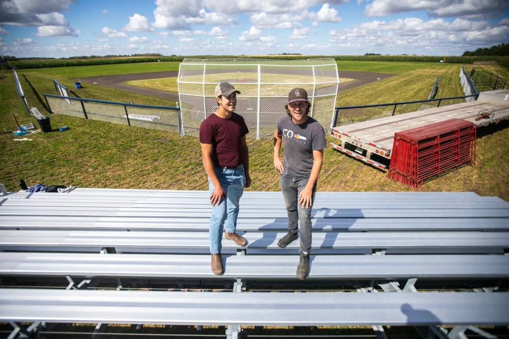 Jace Guilford (left) and Joe Gardiner at the Field of Dreams baseball diamond near Clearwater on Thursday. The field will play host to a baseball tournament and other events today in the small community southeast of Brandon. See story on Page B2. (Mikaela MacKenzie/Winnipeg Free Press)