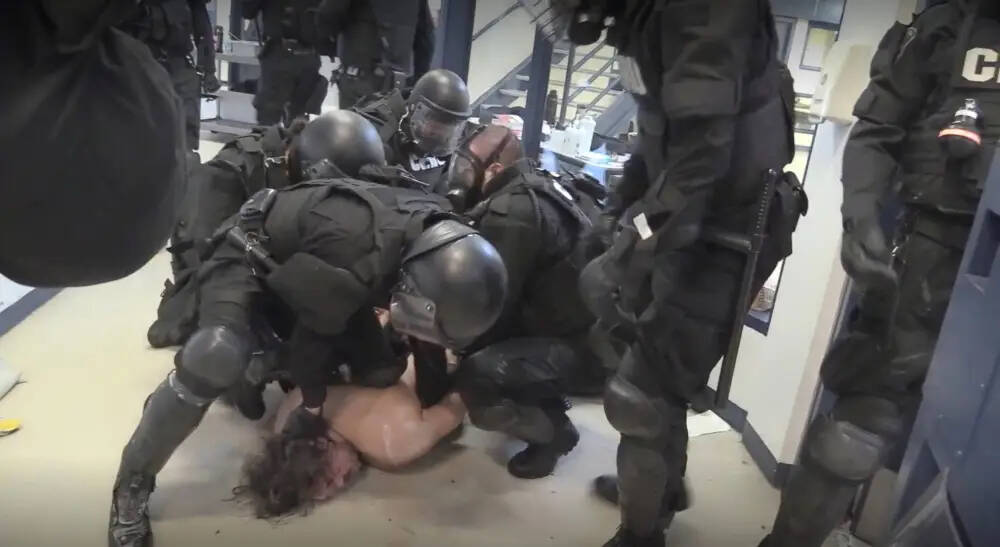 A still from video evidence presented at court during the trial of Robert Jeffrey Morden. William Ahmo, pinned to the floor and fully restrained, told corrections officers more than a dozen times that he couldn’t breathe.