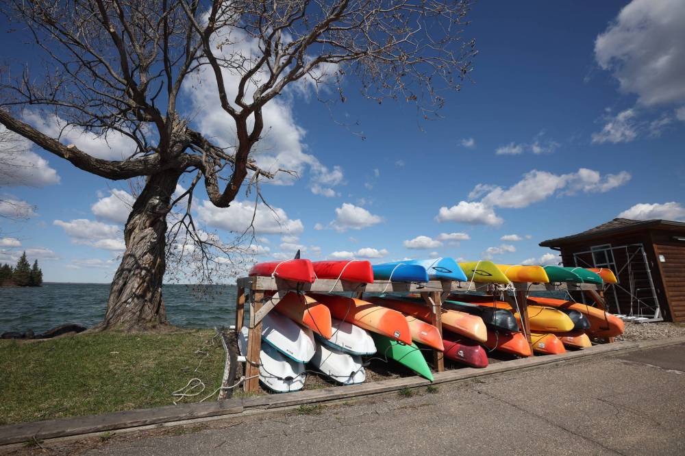 Kayaks stacked at the Clear Lake Marina along the pier in Wasagaming. The ban on all watercraft remains in place. (File)
