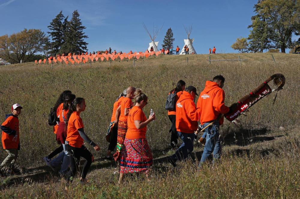 Participants walk through the site of the former Brandon Indian Residential School during the Orange Shirt Day Walk as part of Truth and Reconciliation Week in 2022. Truth and Reconciliation Week takes place Friday through Oct. 4, with a variety of events taking place at the Riverbank Discovery Centre. The Orange Shirt Day is scheduled for Monday — the National Day for Truth and Reconciliation. (File)