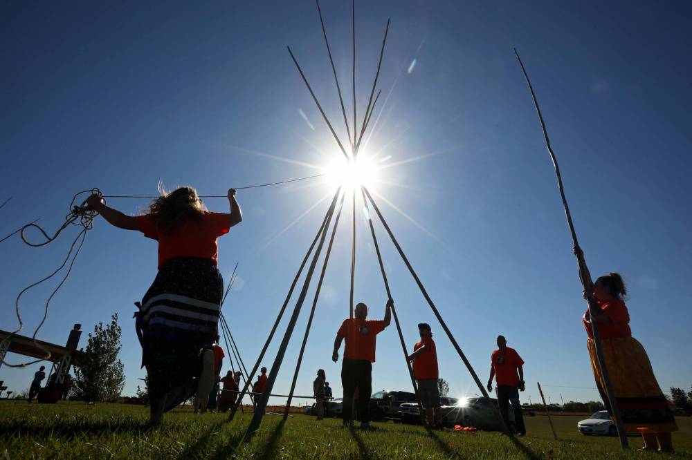 Volunteers work together to set up teepees during the community teepee raising and teachings at the Riverbank Discovery Centre on the first day of Truth and Reconciliation Week 2024 programs on Friday. (Tim Smith/The Brandon Sun)